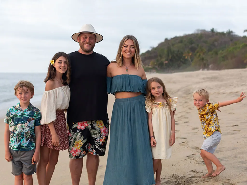 Jennifer Koppes with her husband and their four children on a sunny beach