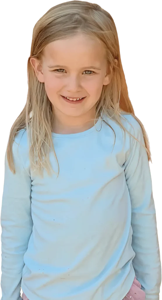 A smiling school-age girl with long blond hair in a light blue top