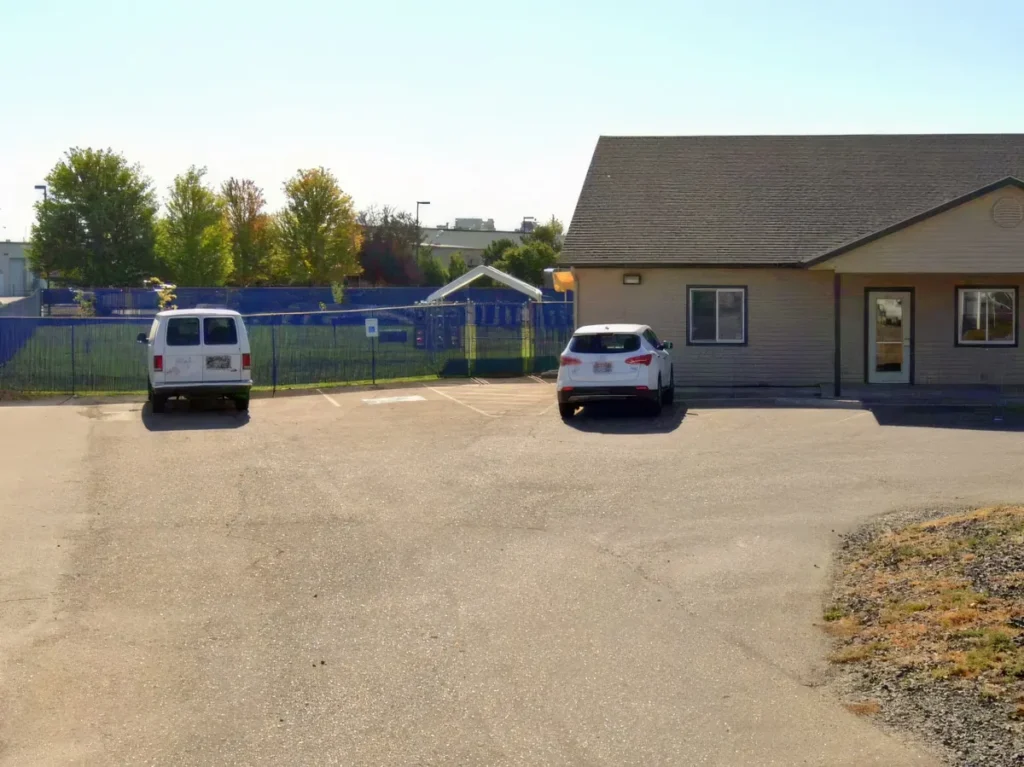 The center’s parking lot, with two cars parked in front of the building